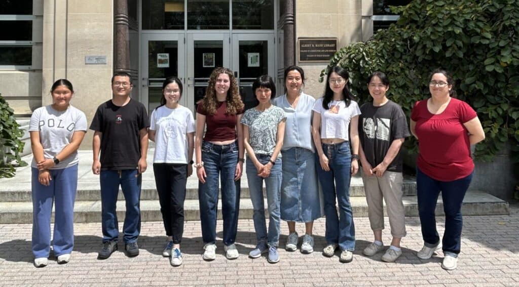 Researchers and staff at Boyce Thompson Institute standing outdoors in front of the library, showcasing a diverse team dedicated to plant science and biomedical research.