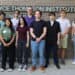 Diverse group of students standing in front of Boyce Thompson Institute sign, highlighting STEM education and botanical research programs at Boyce Thompson Institute.