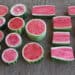 A collection of various sizes and shapes of watermelon cut open to show their insides