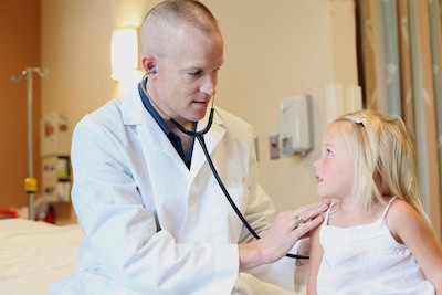 Pediatric doctor examining a young girl in a medical clinic setting, highlighting healthcare for children and child medical care services at Boyce Thompson Institute.